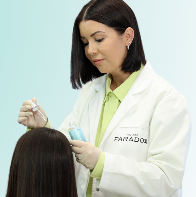 Yolanda Cooper applying serum to hair